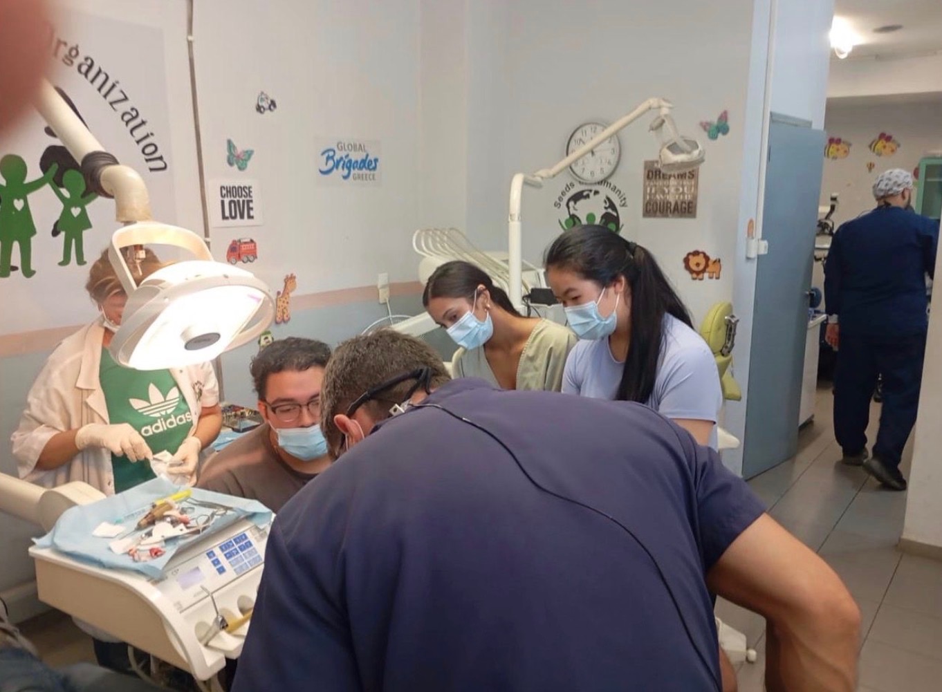 Clinical team treating a patient at the Global Brigades Greece clinic in Athens